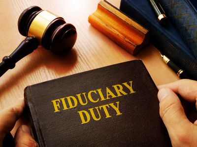 Hands holding Fiduciary duty in an court.