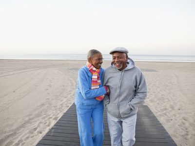 Older adult couple walking on beach