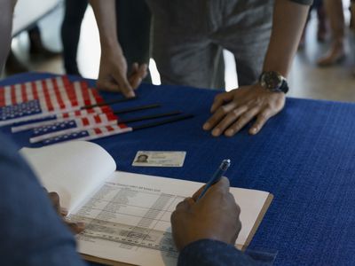 A volunteer checking voters in at polling place.