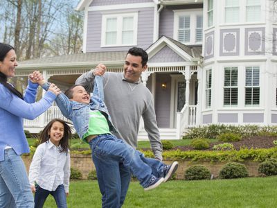 Hispanic family playing in front yard