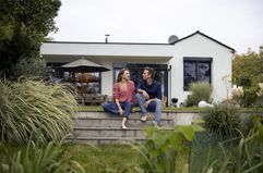 Couple talks on steps in their backyard