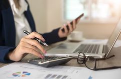 Close up of female accountant or banker making calculations.