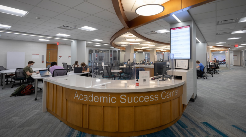 Curved wooden desk with a sign, Academic Success Center