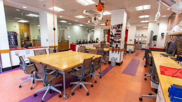 Large work tables and a pegboard with tools