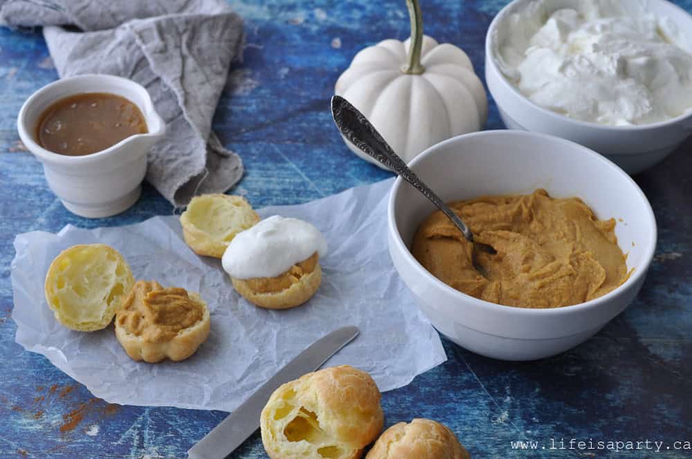 Pumpkin Cream Puffs: A cream puff filled with pumpkin pastry cream, whipped cream, and topped with warm caramel sauce for the perfect fall dessert.