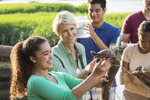 Volunteer teaching kids about nature