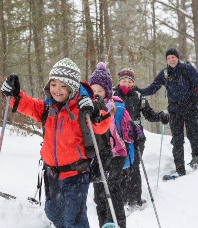 A group of children snowshoeing