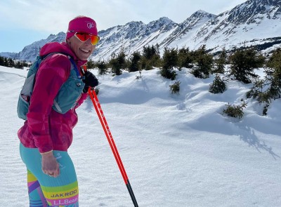 Kikkan Randall cross-country skiing in a beautiful mountain range.