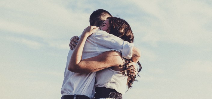 man and woman hugging