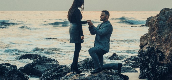 man kneeling in front of a woman