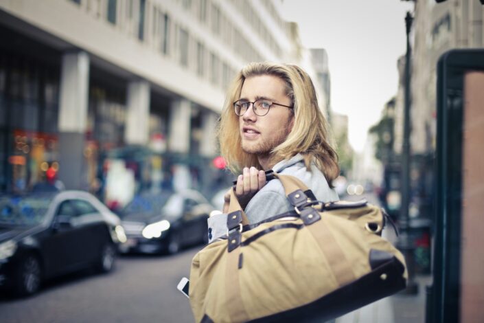 man-holding-his-duffel-bag-