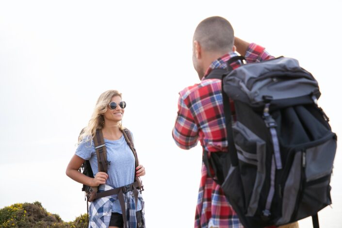 a-man-taking-a-picture-of-a-woman-wearing-sunglasses-