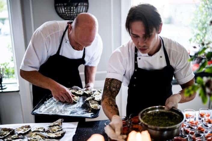 Two men cooking at the kitchen