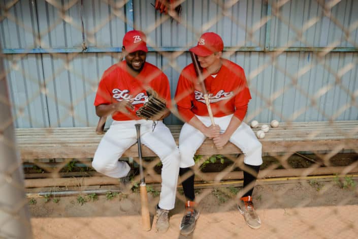 Diverse baseball players sitting