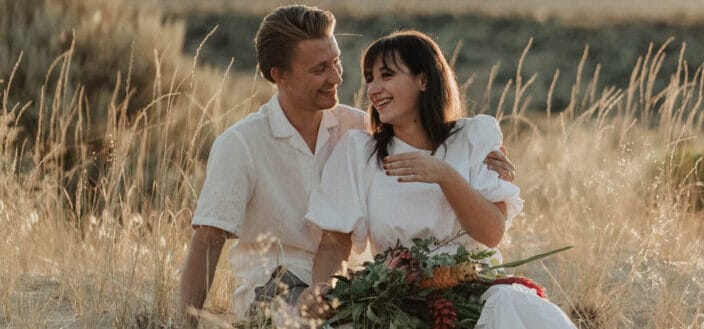 Happy couple enjoying romantic date in rural field