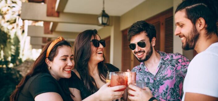 woman in black shirt holding drinking glass