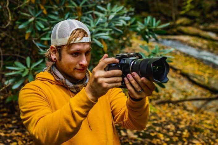 Man Holding a Camera And Taking a Photo