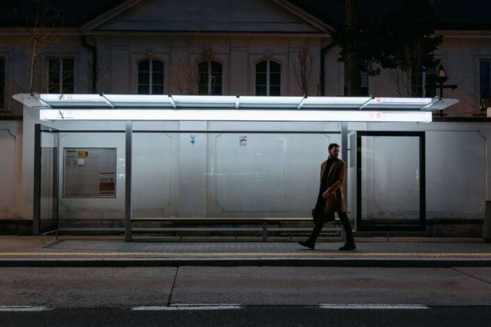 man walking on sidewalk at night