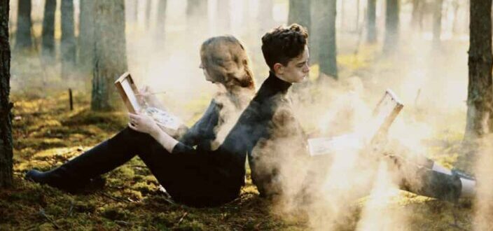 Couple Reading Books in Forest