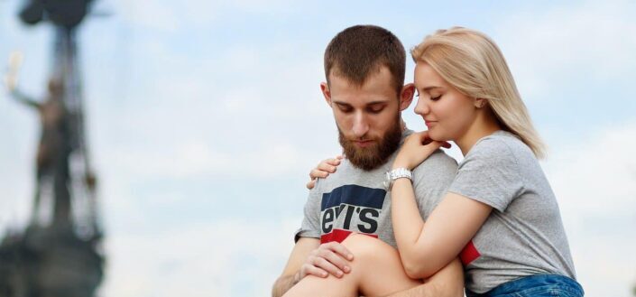 Young sweet couple sitting on a park