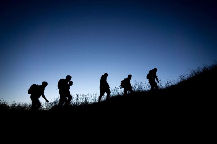 backpackers traveling at night