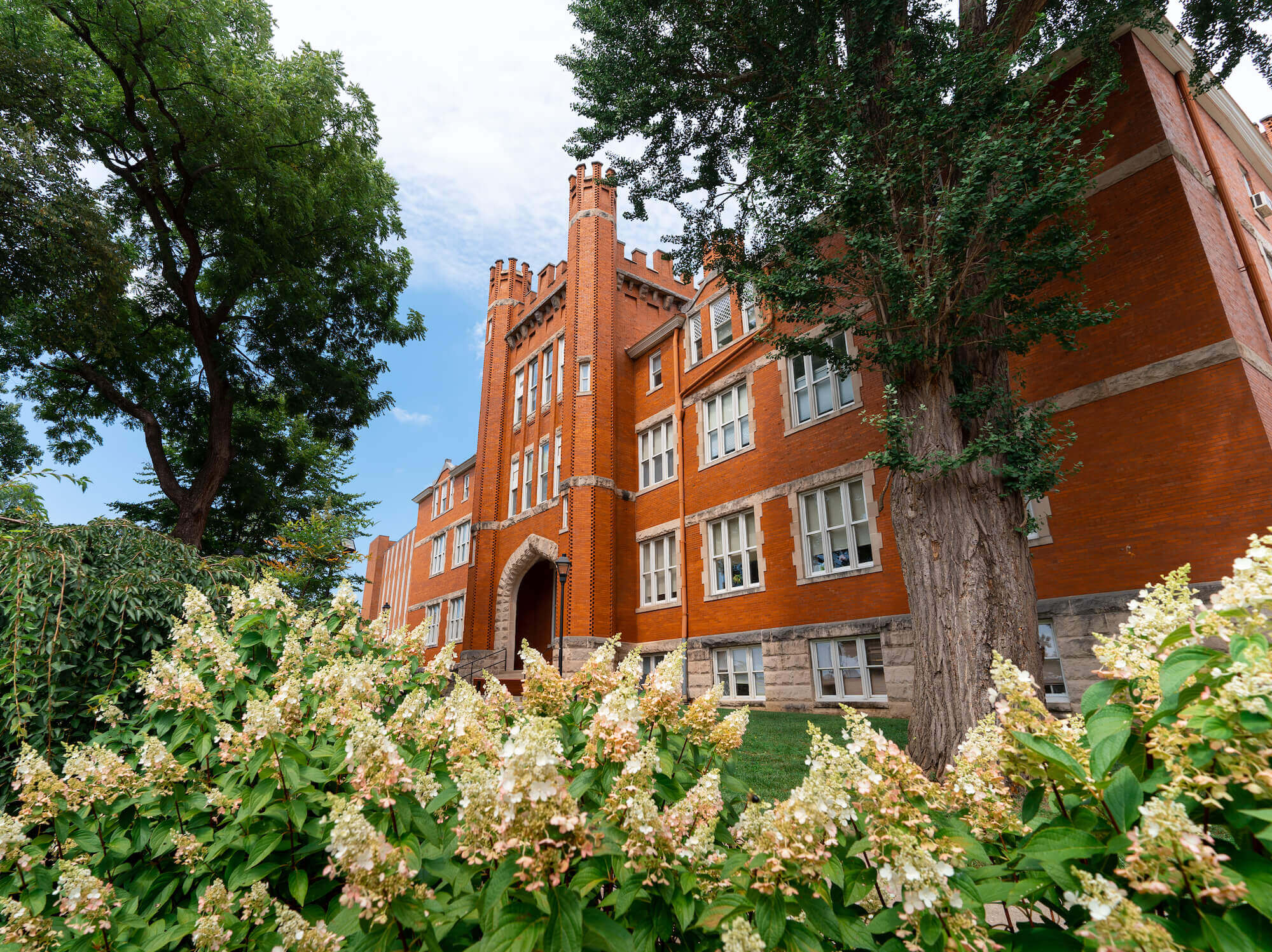 Photo of Old Main with flowers