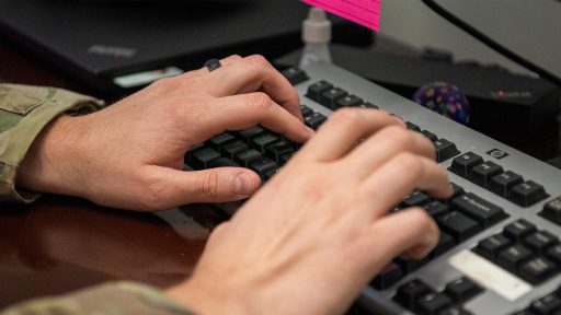 hands typing on keyboard