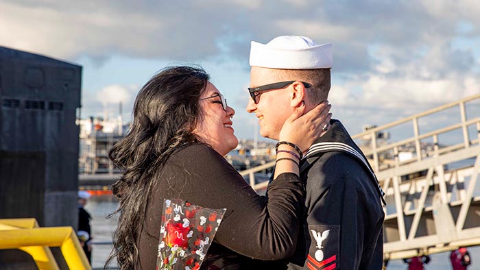 service member hugging spouse