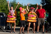 Hundreds of people line Main Street to watch during the Parade of Tropical Fools at the Cheeseburger Festival in Caseville on Wednesday, Aug. 14, 2019.