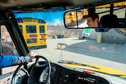 Driver Stuart Collins sits at the wheel of a Thomas Safe-T-Liner C2 electric school bus at Ann Arbor Public Schools Transportation Services Building, 2400 Boardwalk Drive in Ann Arbor on Tuesday, March 12, 2024.