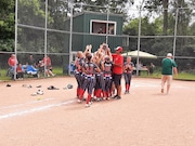 Hanover-Horton softball players celebrate their district championship Saturday after beating Lumen Christi