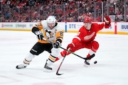 Pittsburgh Penguins center Sidney Crosby (87) shoots as Detroit Red Wings' Simon Edvinsson (3) defends in the second period of an NHL hockey game Saturday, April 8, 2023, in Detroit. (AP Photo/Paul Sancya) AP
