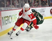 Former Red Wings prospect and Grand Rapids Griffins' defenseman Jared McIsaac skates away from Iowa Wild winger Patrick Curry in a game on Nov. 3, 2022 (Photo credit: Tim Garland)