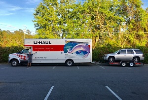 Towing a car behind a moving truck