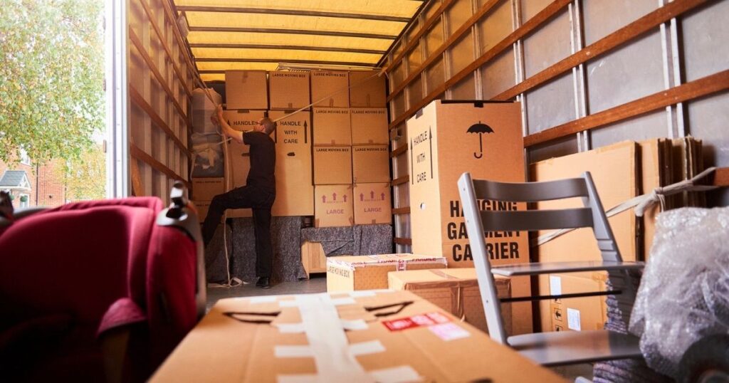 A person packing a moving container