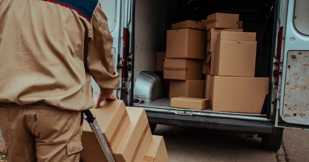 professional mover putting boxes into a moving van