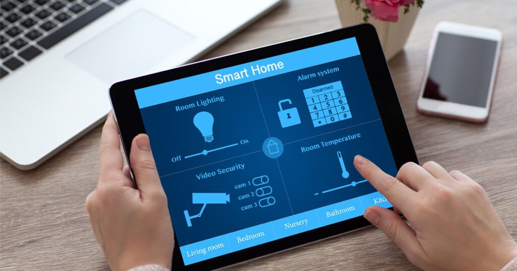 Woman holding a tablet feature smart home applications near a smartphone and a laptop