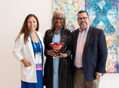 Mobile County, Ala. Commissioner Merceria Ludgood accepts the Public Leadership in the Arts Award July 13 from Jay Dick of Americans for the Arts and Dakota County, Minn. Commissioner Mary Hamann-Roland, who chairs the NACo Arts and Culture Commission, at the Tampa Museum of Art. Photo by Denny Henry