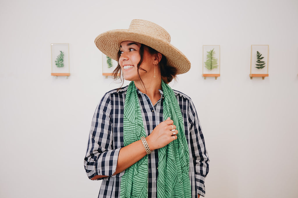 girl in palaka dress and papale hat smiling