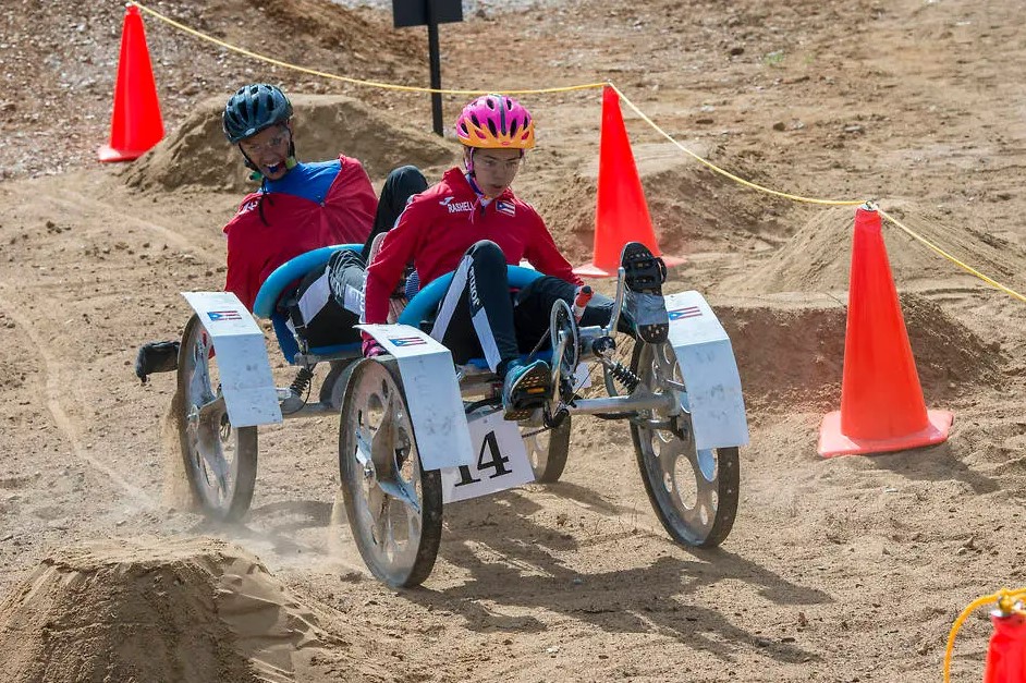 Two students man a rover built for the Human Exploration Rover Challenge (HERC).