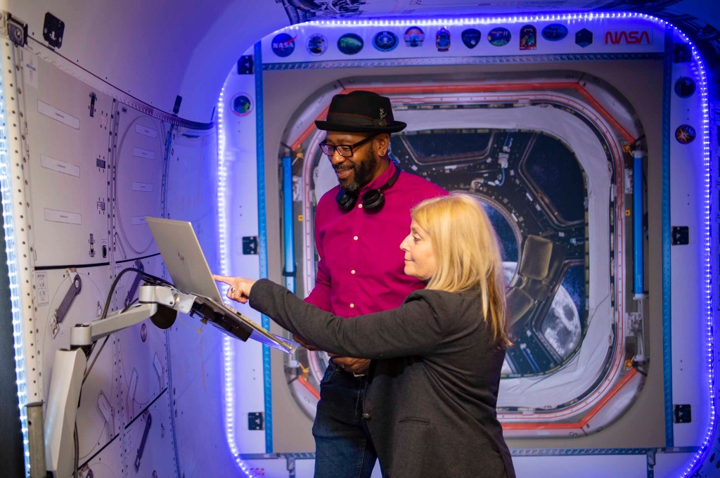 Lauren Underwood and Travis Martin review data on laptop inside Autonomous Systems Lab