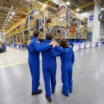 Artemis II NASA astronauts Reid Wiseman and Christina Koch of NASA, and CSA (Canadian Space Agency) astronaut Jeremy Hansen view the core stage for the SLS (Space Launch System) rocket at the agency’s Michoud Assembly Facility in New Orleans on Nov. 16.