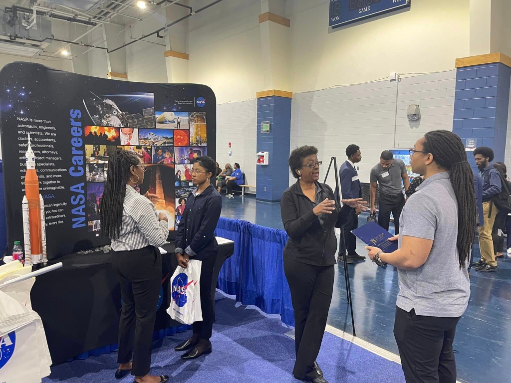 crowd shot captures career expo attendees standing in front of NASA Careers display