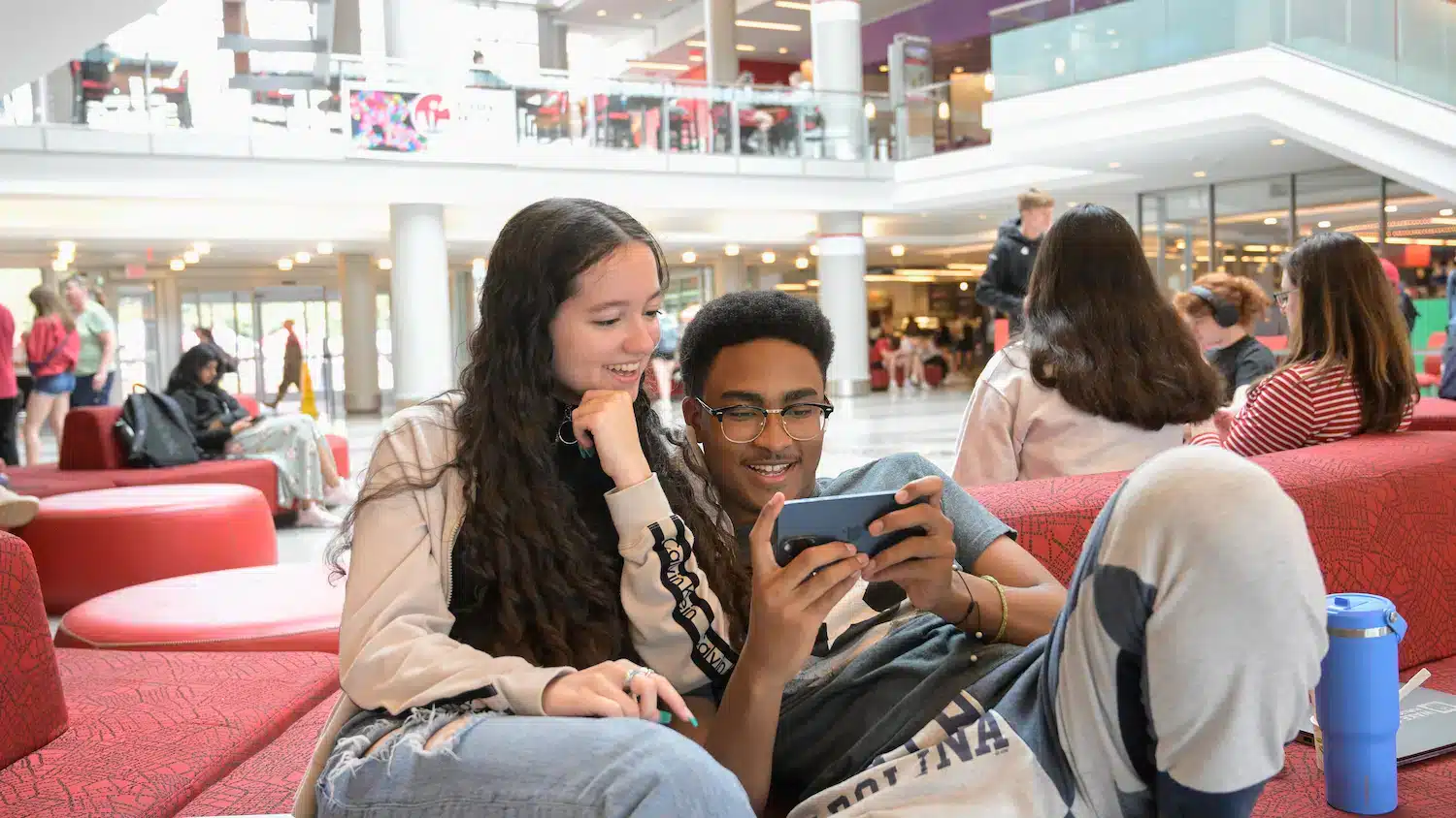 Two NC State students share a screen in Talley Student Union.