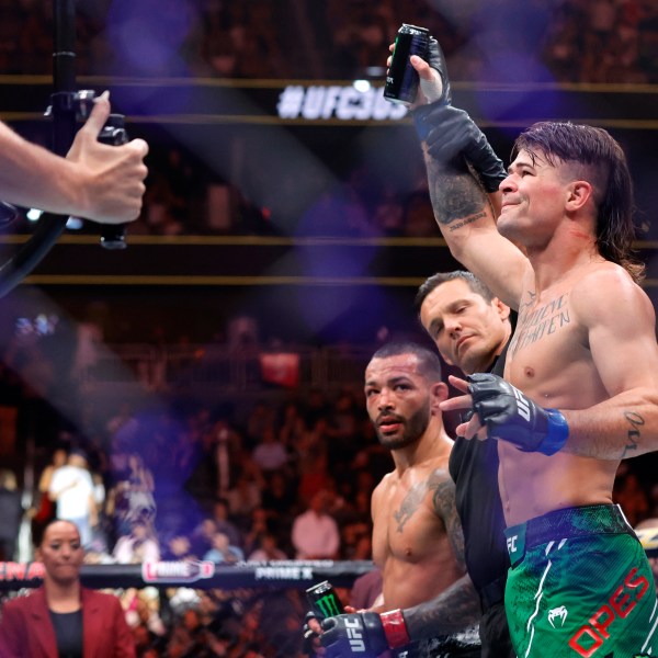 Diego Lopes, right, is declared the winner by unanimous decision over Dan Ige in a 165-pound catchweight mixed martial arts bout at UFC 303, Saturday, June 29, 2024, in Las Vegas. Ige replaced Brian Ortega, who withdrew from the bout due to illness. (Steve Marcus/Las Vegas Sun via AP)