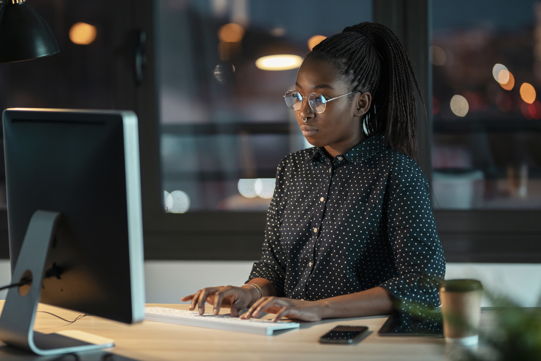 Shot of pretty happy entrepreneur woman working with laptop sitting in the office.