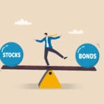 Stocks vs bonds in investment asset allocation, risk assessment portfolio or expected return in long term mutual funds, pension fund concept, businessman investor balance on stocks and bonds seesaw.