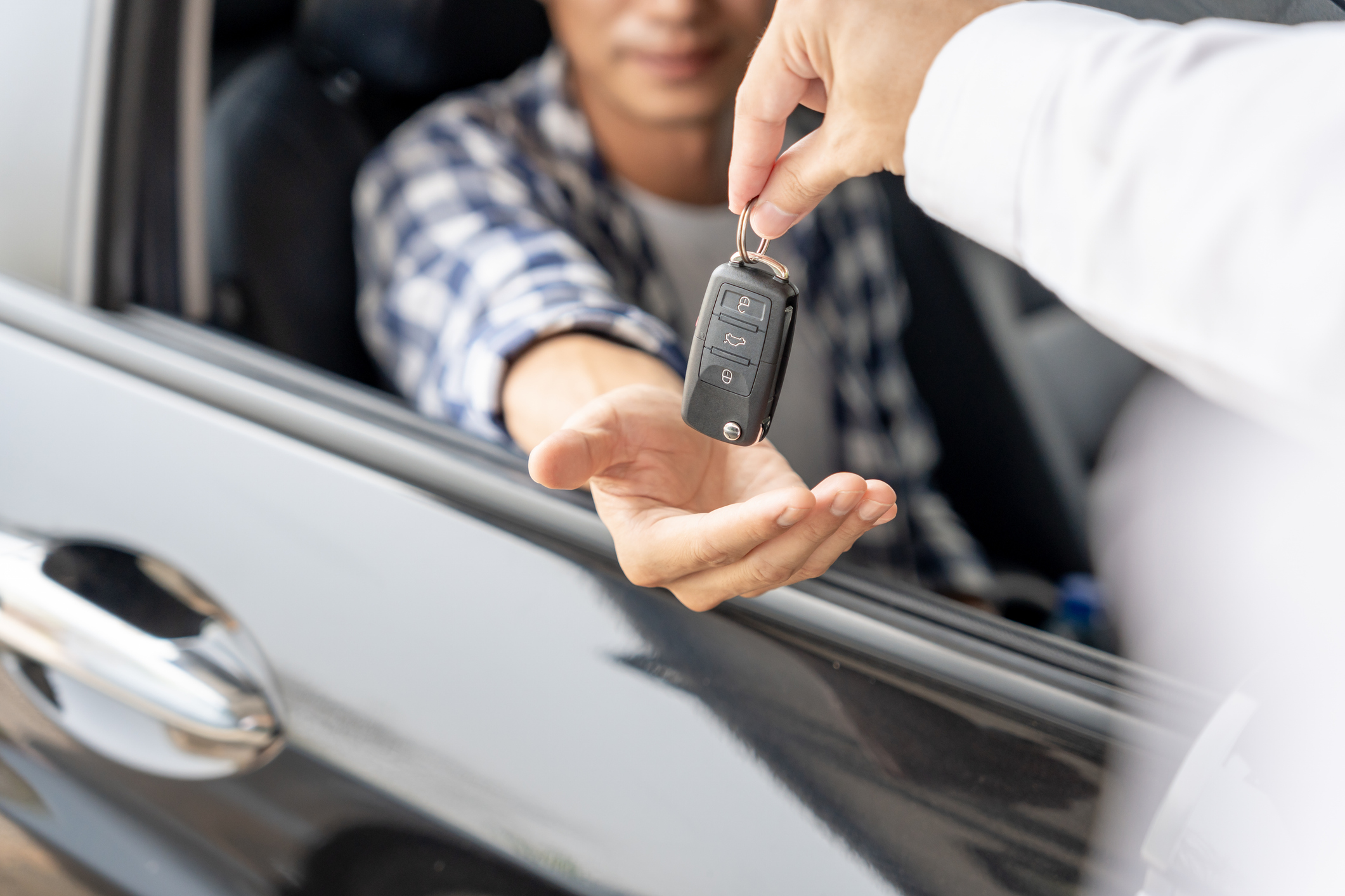 Dealership manager send car keys to the new owner