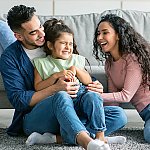 Parents having fun with their young daughter at home