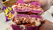 The Takis bagel from Bagel Nook in Freehold. The bagel is made with a purple dough and crusted with Takis, a spicy tortilla chip, before being loaded up with ranch vegetable cream cheese and more Takis. (Jeremy Schneider | NJ Advance Media for NJ.com)